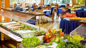 A buffet with various food items and a seating area with tables and chairs. - Hotel Laguna Garden (Albena)