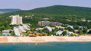 A coastal resort with beachfront hotels, a sandy beach, and a mountainous backdrop. - Hotel Laguna Garden (Albena)