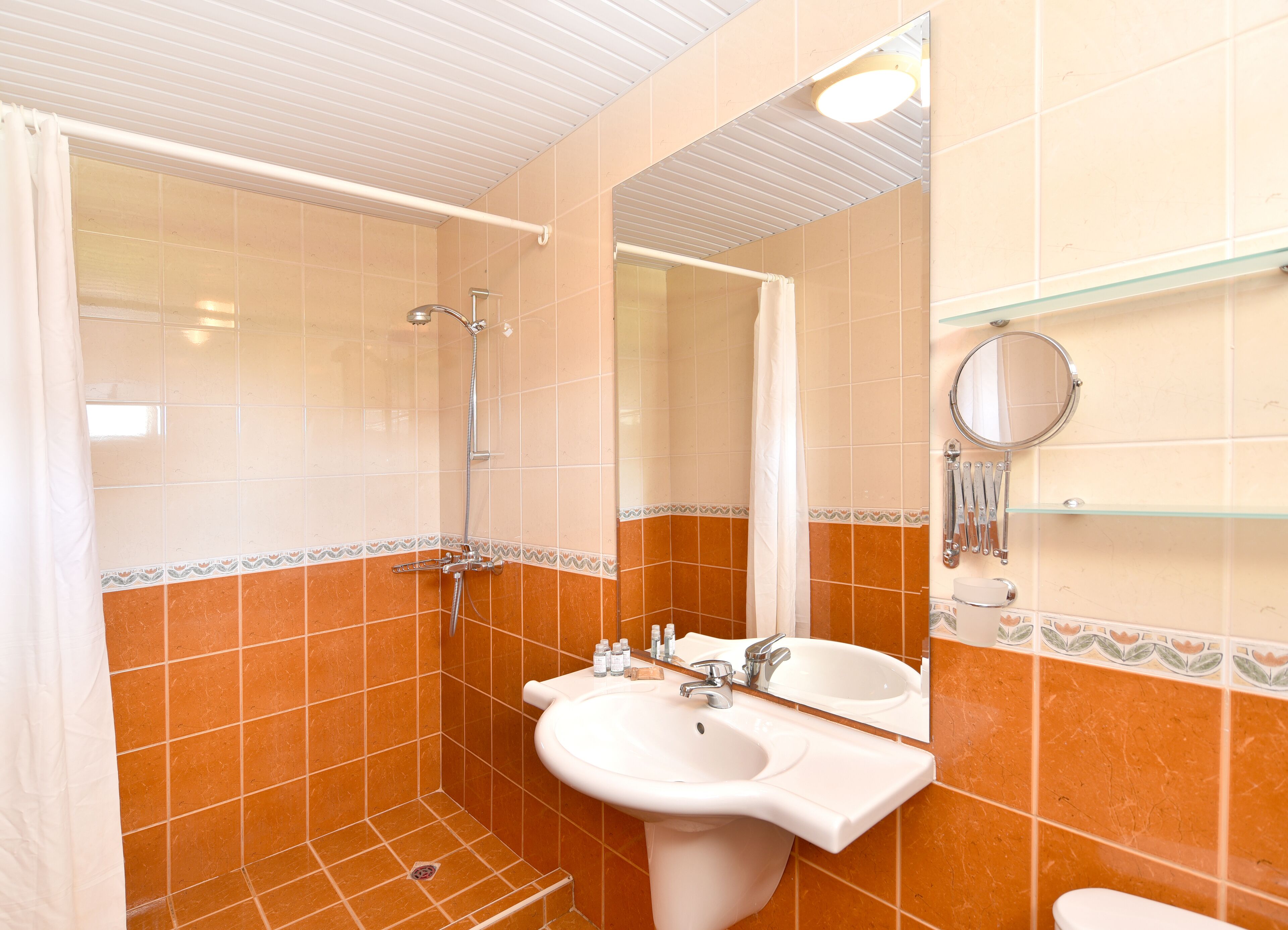 shower, hair dryer, slippers, towels