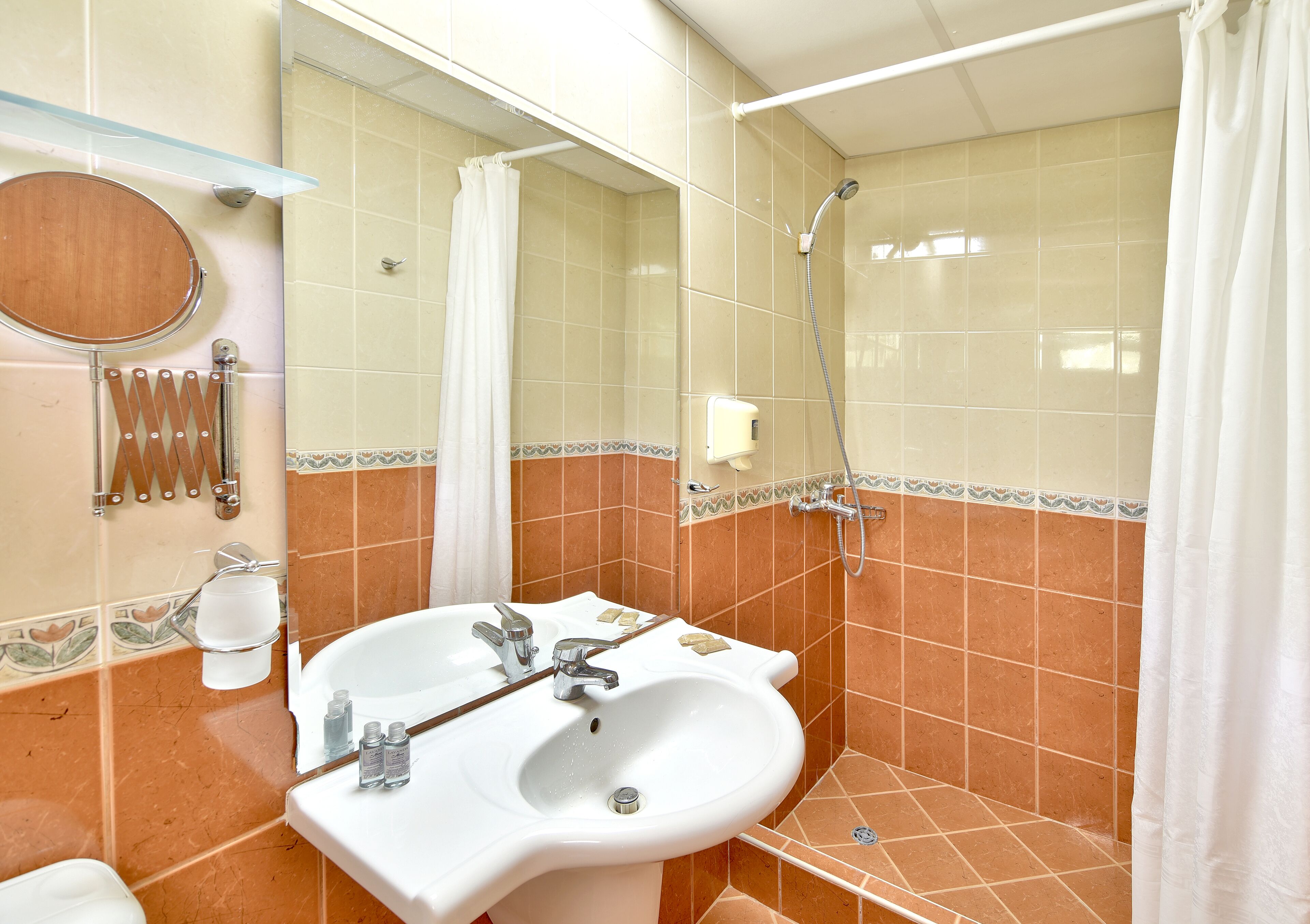 shower, hair dryer, slippers, towels