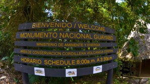 A welcome sign for Monumento Nacional Guayabo, including the schedule. - Hotel Wagelia Turrialba (Turrialba)