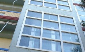 A multi-story building with a grid of windows on the facade. - Hotel Cybele (Lykovrysi-Pefki)