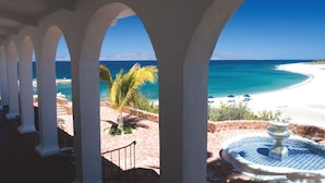 A covered outdoor area with a view of a beach and ocean. - Rancho Las Cruces Baja California Sur (Las Cruces)