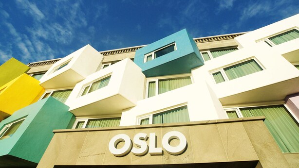 A multi-story building with the word "OSLO" prominently displayed on the facade.