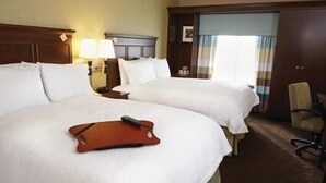 A hotel room with two large beds, a desk with a lamp, a chair, and a window with curtains. - Hampton Inn & Suites Monroe (Monroe)