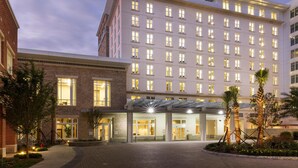 A multi-story hotel with a modern facade, large windows, and a covered entrance area. - Hyatt House Charleston/Historic District (Charleston)