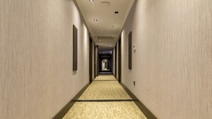 A long, narrow hotel corridor with carpeted floors and recessed lighting. - Ankara Royal Hotel (Ankara)