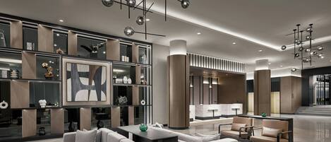 A modern lobby with a reception desk, seating area, and decorative lighting.