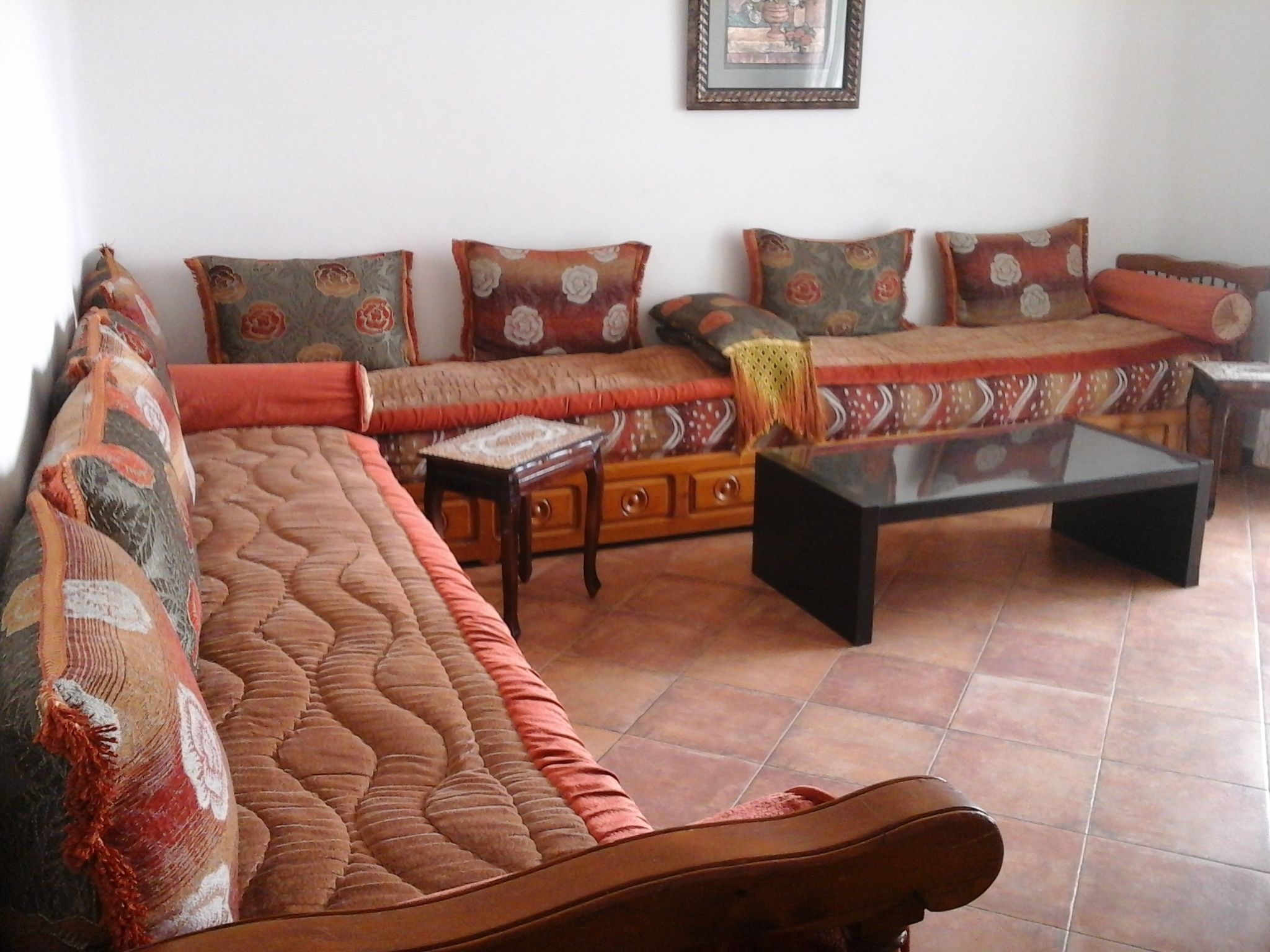 A living room with a sofa set, a coffee table, and a small side table.