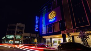 A hotel with a prominent neon sign, a modern building facade, and a visible entrance. - Golden Roof Hotel Ampang Ipoh (Ipoh)