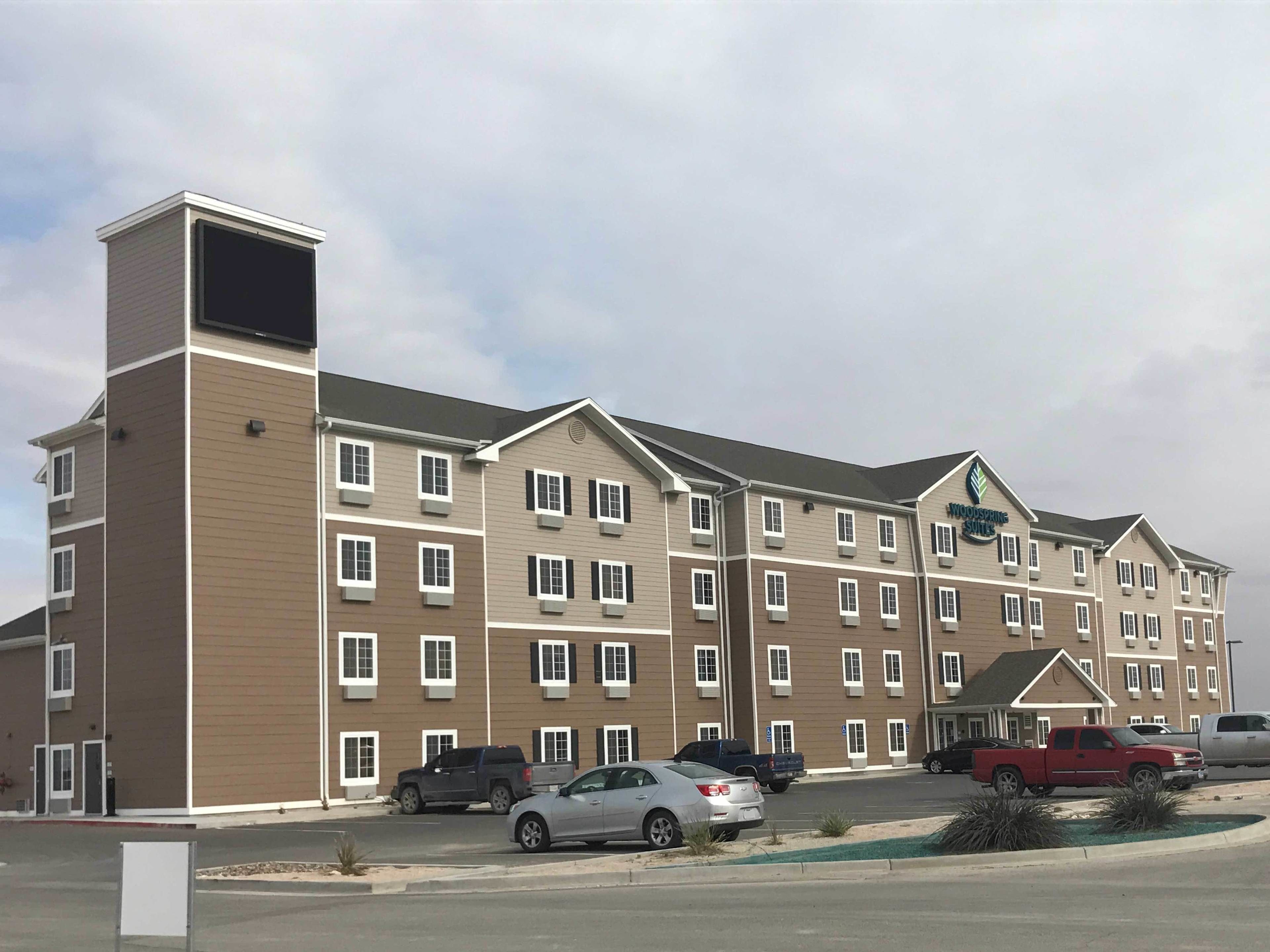 A multi-story hotel with a flat roof and a central entrance.