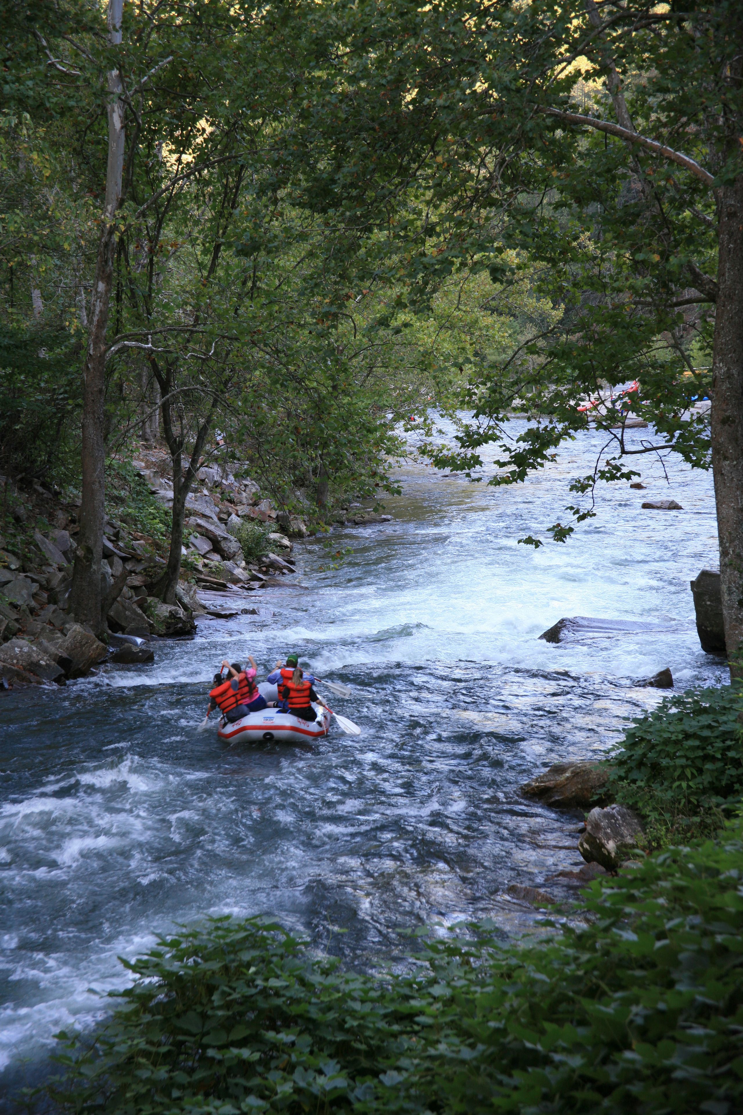 A river with a raft carrying two people.