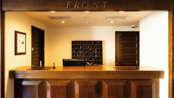 A reception desk with a wooden front panel labeled "FRONT".