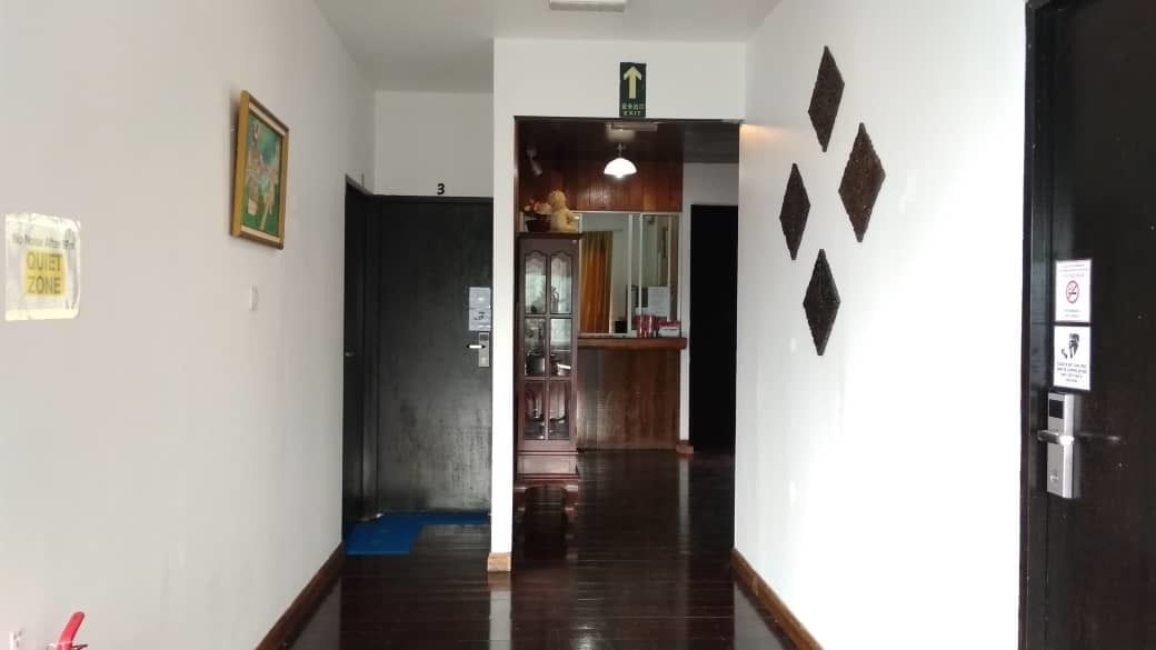 A hallway with a sign indicating a quiet zone, a door marked with the number 3, and a blue mat on the floor.
