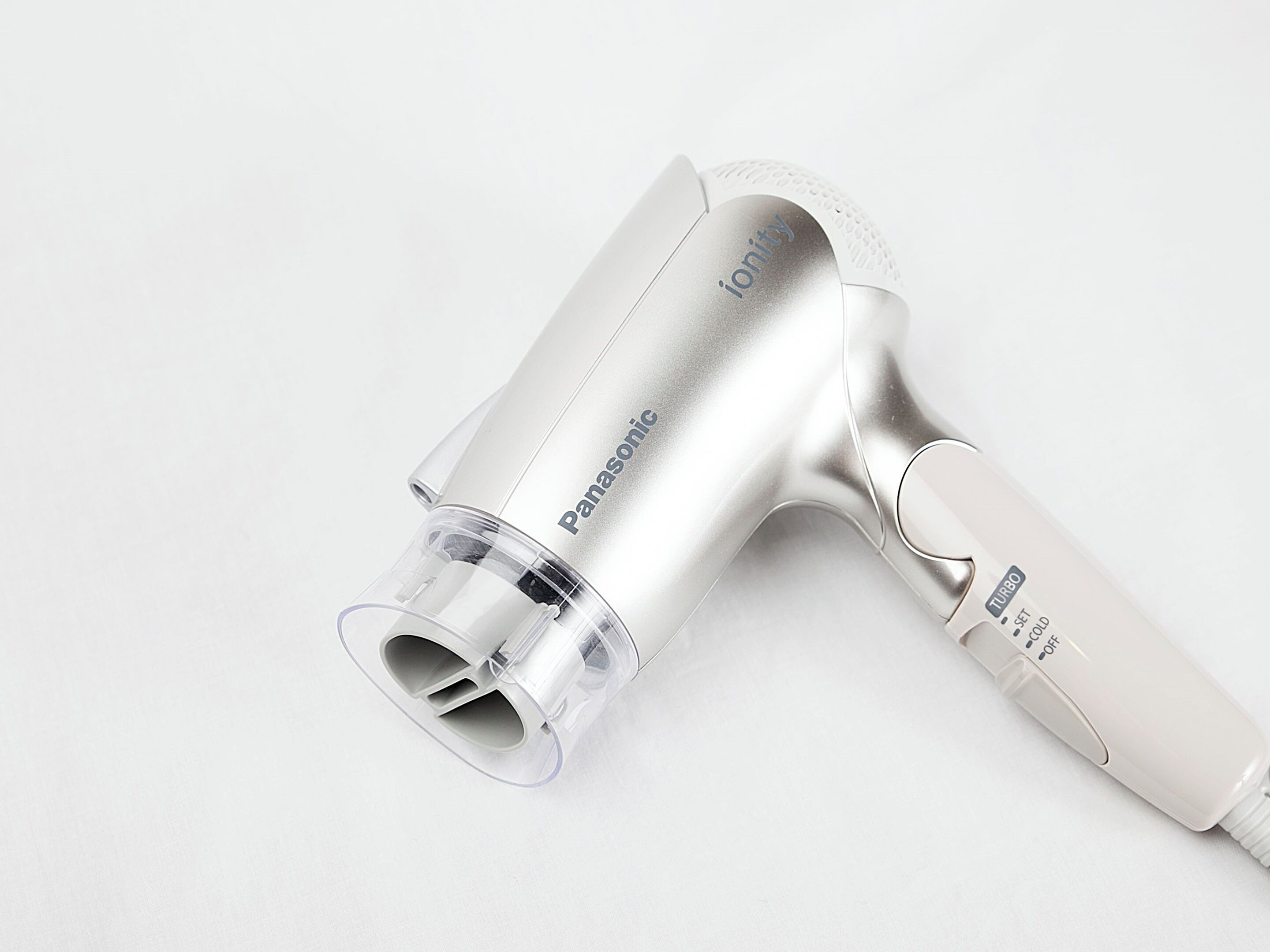 A Panasonic hair dryer with a transparent nozzle and a white handle.