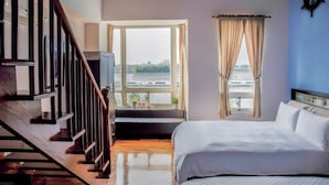 A bedroom with a large window, a bed, and a staircase. - Vanilla Sky (Wujie)