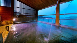 A spacious indoor hot spring area with wooden beams and a view of the mountains. - Toba View Hotel Hanashinjyu (Toba)