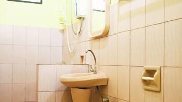 A bathroom with a pedestal sink, toilet, and a mirror.