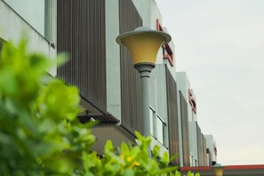 A modern building with vertical slats and a street lamp. - The Centro Hotel & Residence by Orchardz (Batam)