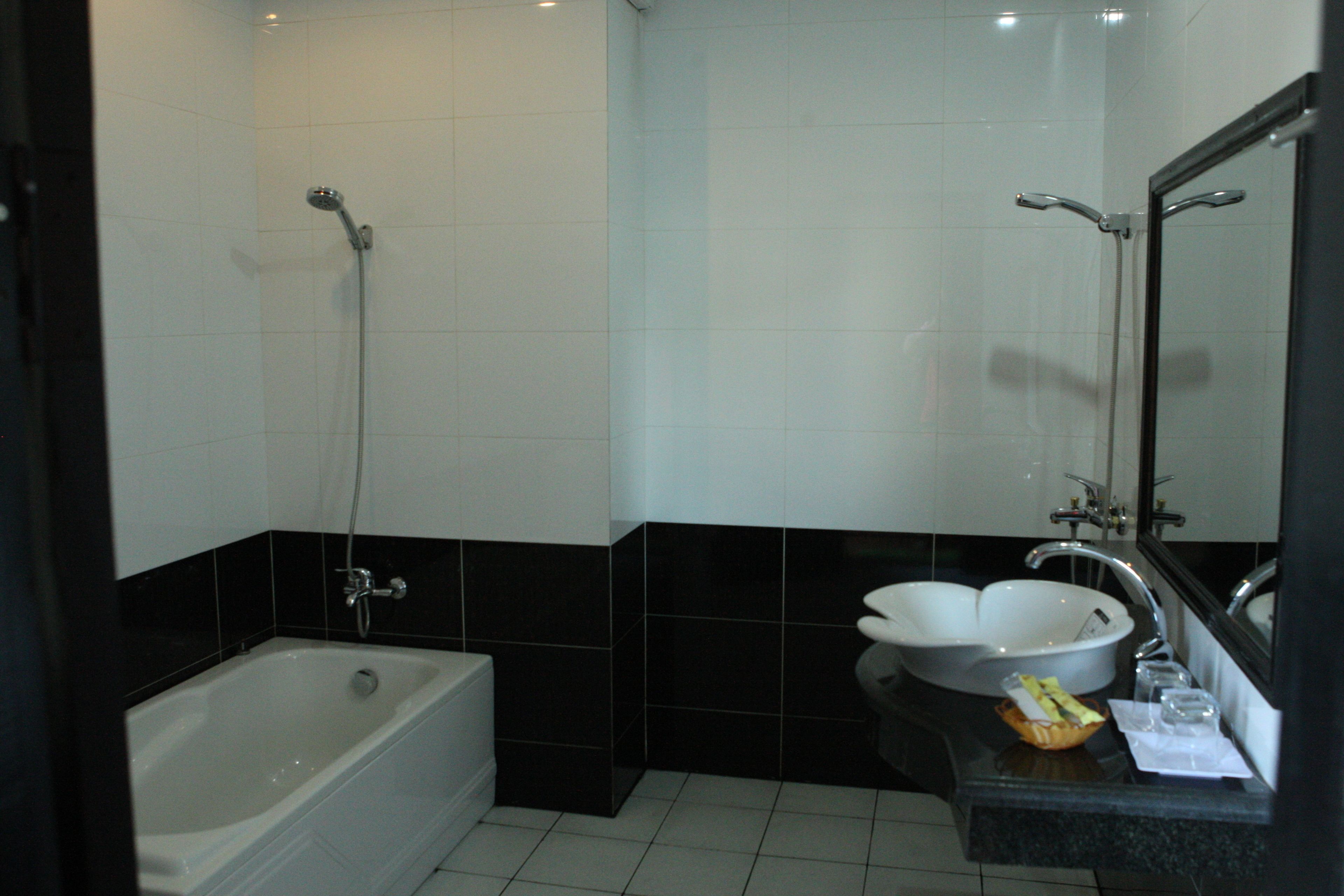 A bathroom with a bathtub, a sink, and a shower.