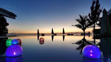 Outdoor pool, an infinity pool, open 7:00 AM to 6:00 PM, pool umbrellas