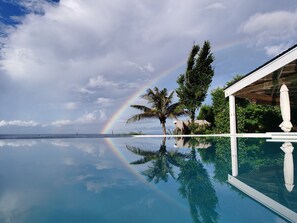 Outdoor pool, an infinity pool, open 7:00 AM to 6:00 PM, pool umbrellas - Kawayan Holiday Resort (San Juan)