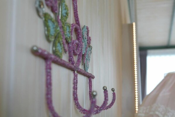 A close-up of a decorative item with multiple strands and metallic elements, possibly a piece of jewelry or an ornament. - Follow Me B&B (Dongshan)