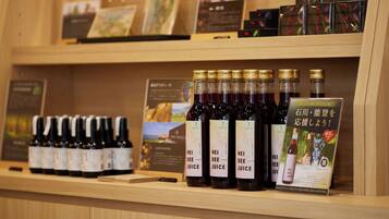 A display of wine bottles and boxes on shelves.