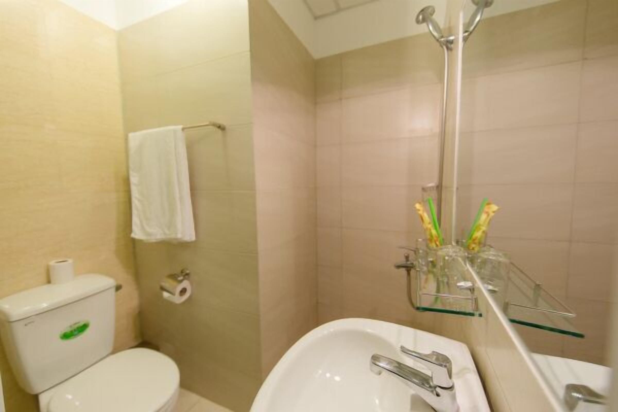 A bathroom with a toilet, a sink, and a shower.