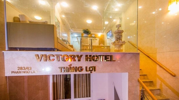 The interior of Victory Hotel with a reception desk, a staircase, and a statue. - Marie-Line Hotel (Ho Chi Minh City)