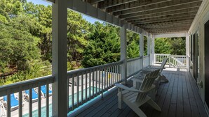 A wooden deck with white railings, a pool, and outdoor seating. - Inn-Seaclusion: Elevator, Private Pool & Hot Tub, Theater Room (Corolla)