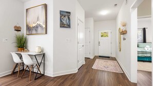 A modern interior with a dining area, a hallway, and a bedroom. - 10 Min From Downtown & Airport! Fenced-In Yard (Charlotte)