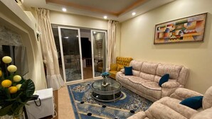 Deluxe Apartment | Living area | 24-inch Smart TV with digital channels
