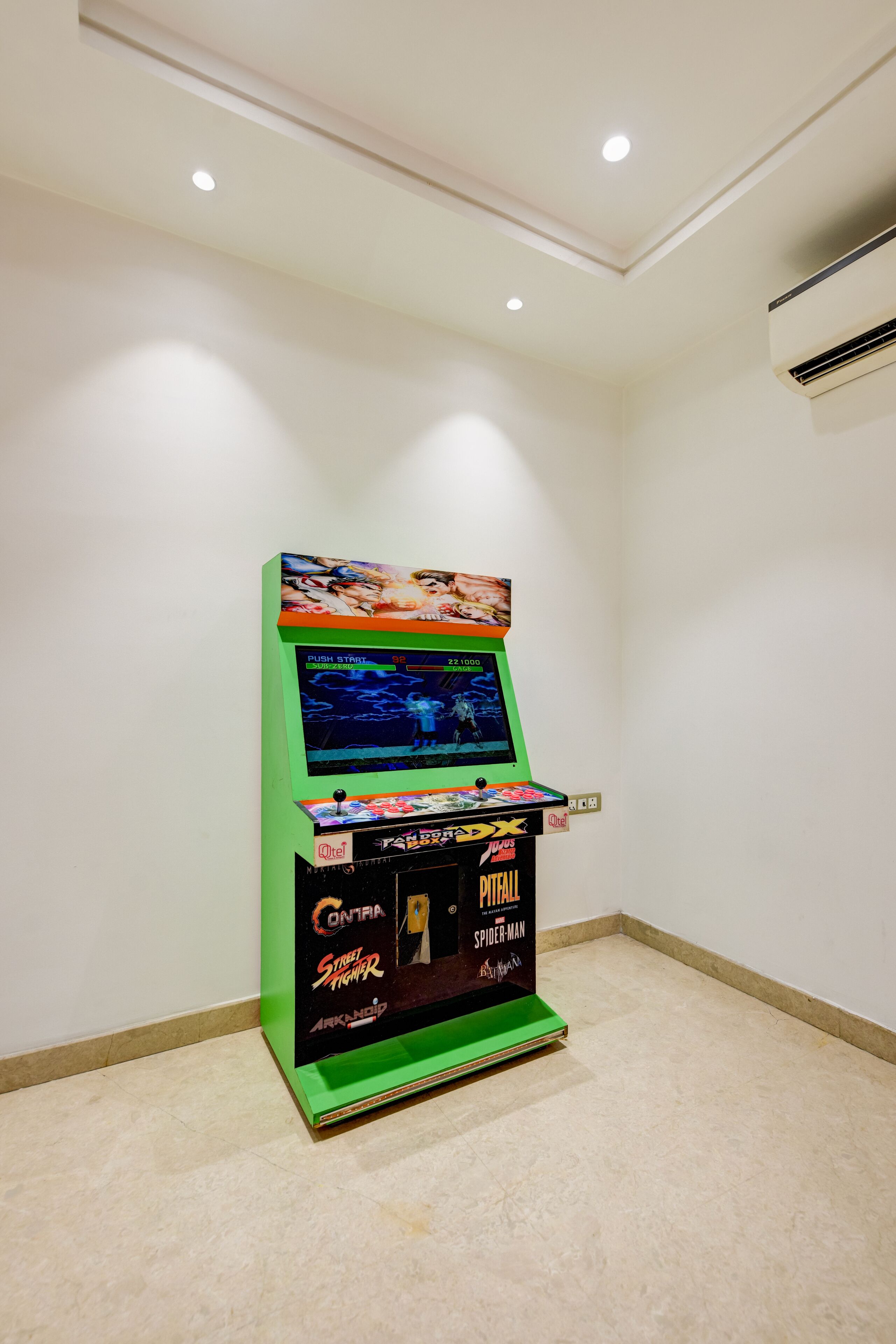 A retro arcade machine with a green base and a screen displaying a game.
