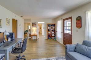 A spacious living room with a computer desk, a comfortable sofa, and a bookshelf. - 2 Mi to Rainbow River: Home in Dunnellon (Dunnellon)