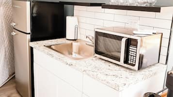 Fridge, microwave, coffee/tea maker, cookware/dishes/utensils