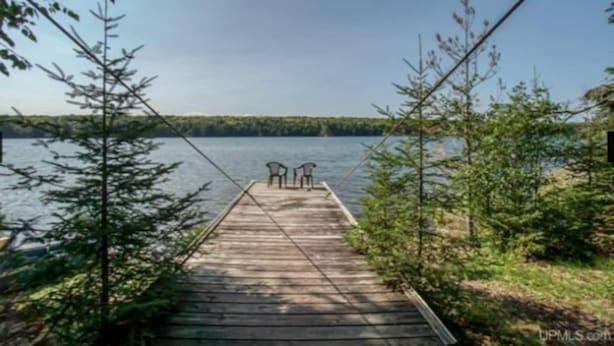 A wooden dock extending into a lake, with two chairs at the end. - Summer is here. Great hiking and the falls are beautiful golf courses open (Iron River)