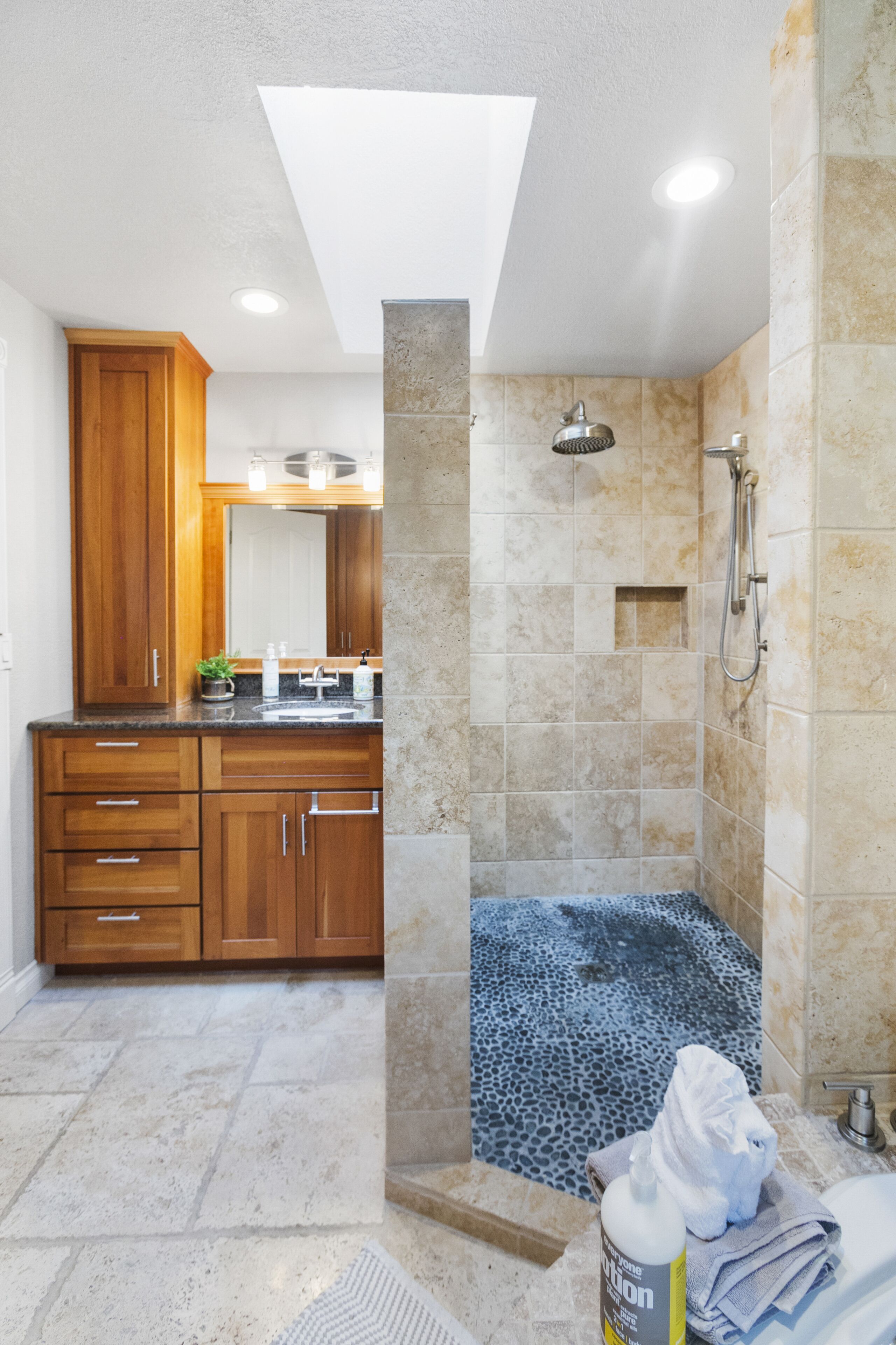 A modern bathroom with a shower, a bathtub, and a vanity with a mirror.