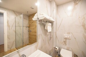 Shower, hair dryer, slippers, towels