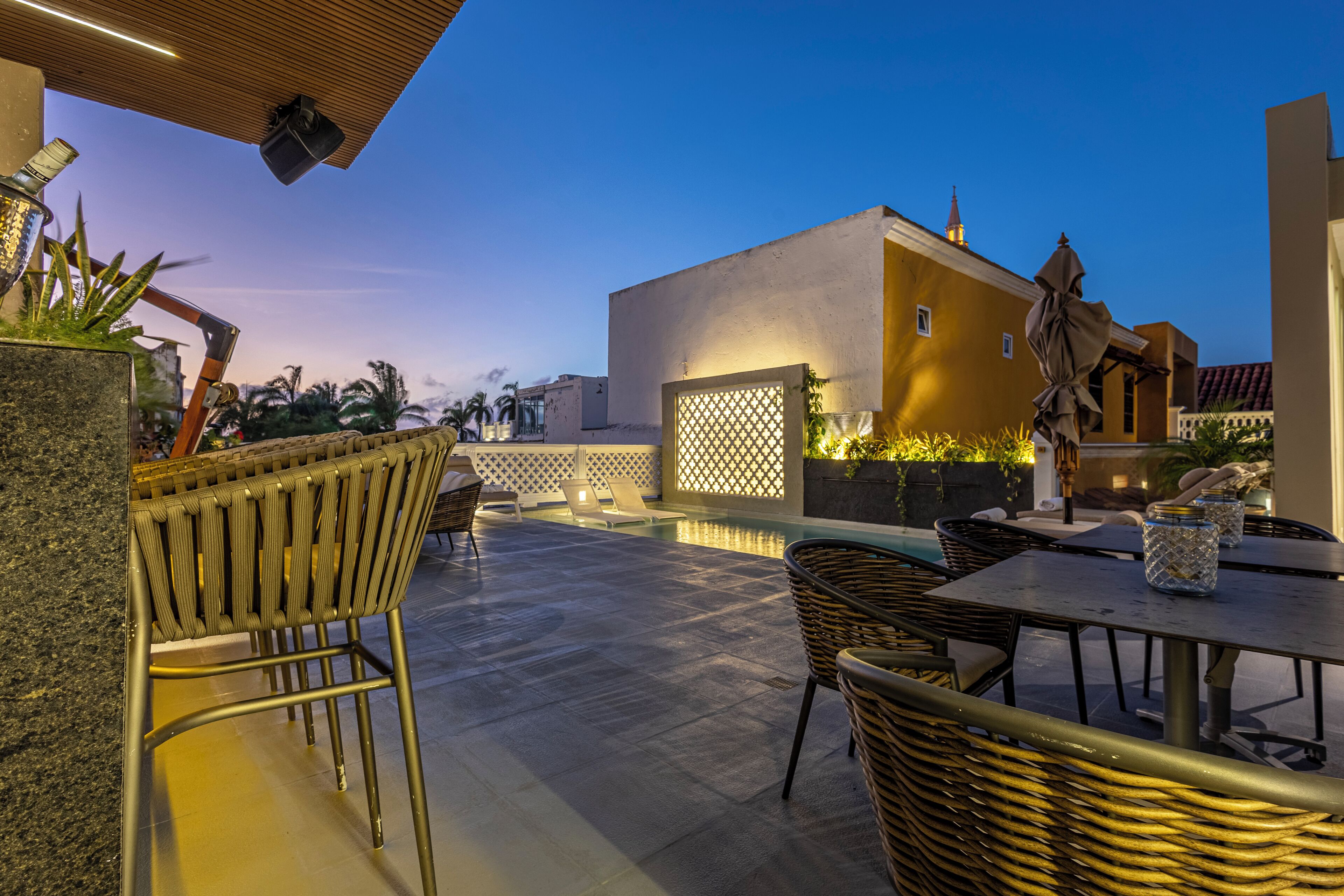 Una piscina al aire libre, sombrillas, sillones reclinables de piscina