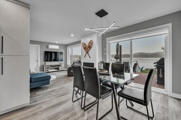 Contemporary vacation rental with bright dining area overlooking the water.