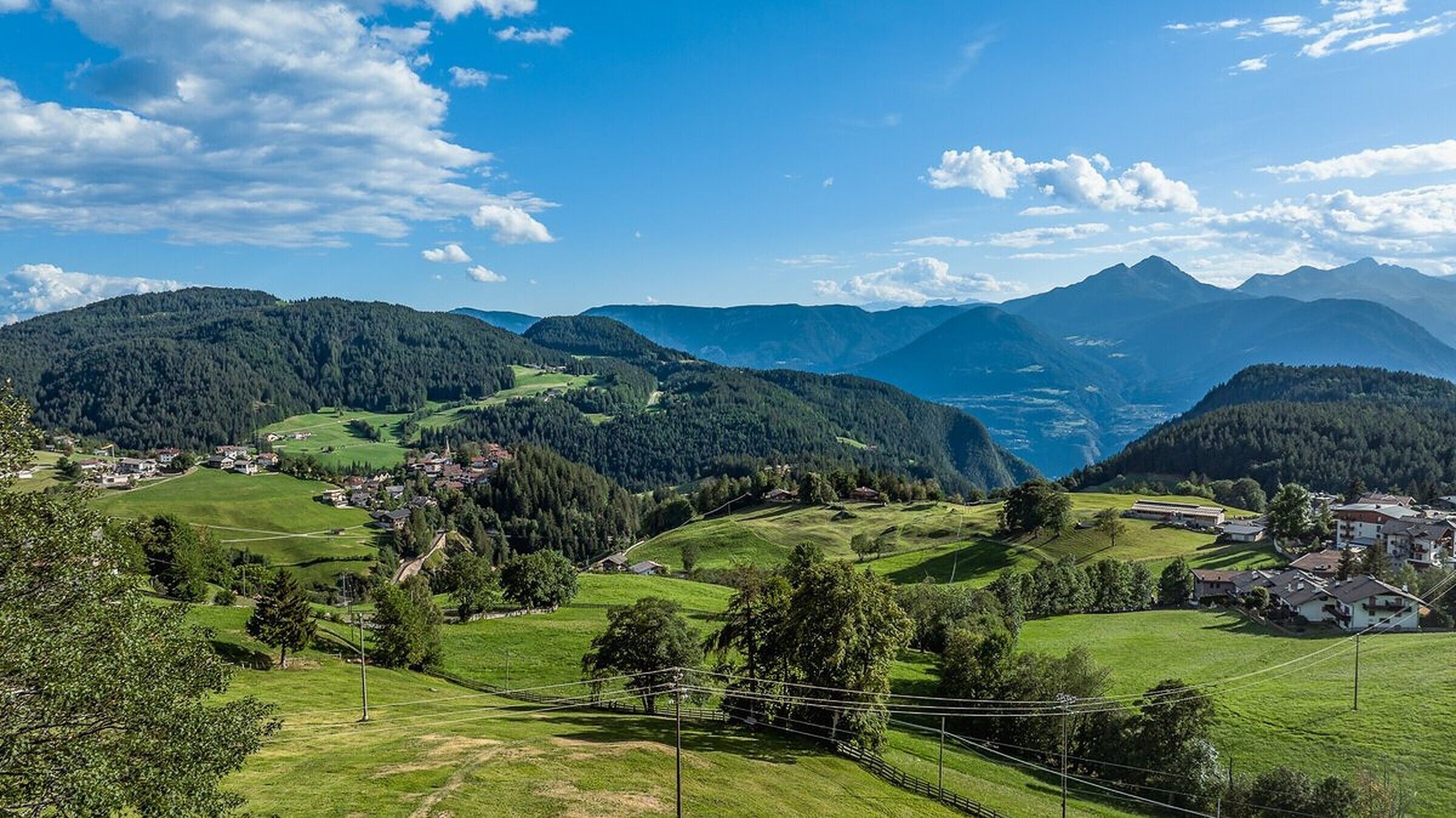 A mountainous landscape with a village nestled in the valley.