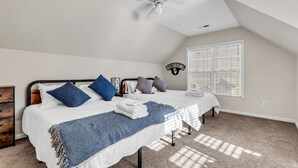 A bedroom with two beds, a ceiling fan, a window with blinds, and a 'RECORDING' sign on the wall.