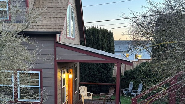Une maison dotée d’un porche abrité, d’une petite terrasse et d’une cour clôturée.