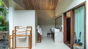 A modern bathroom with a large mirror, two sinks, and a shower area. - The Gardens Seminyak (Seminyak)