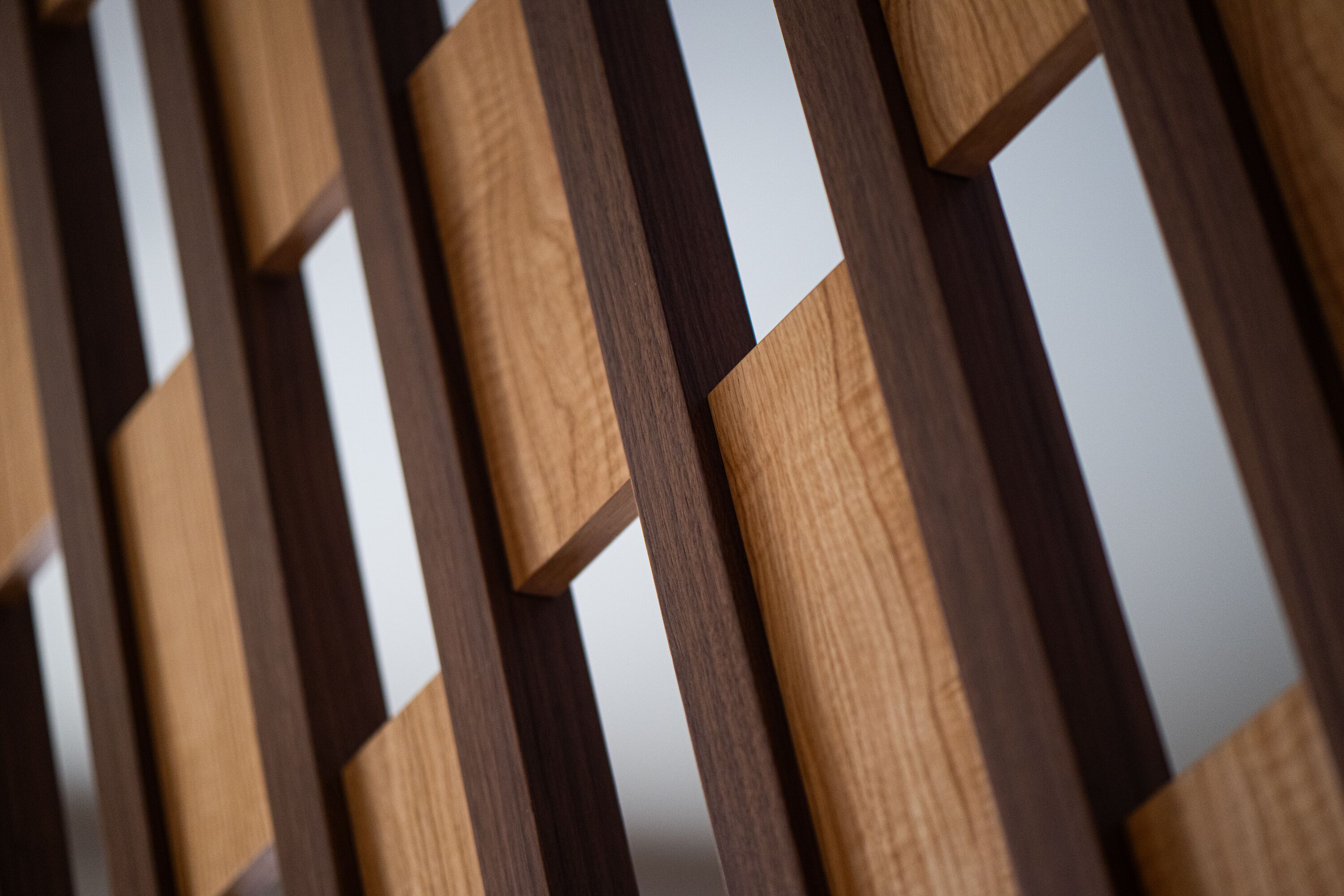 A close-up of a wooden partition with a geometric design.