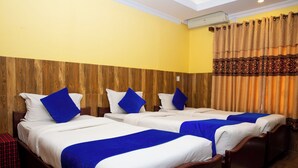 A hotel room with three beds, each with white bedding and blue accents. - Taj Residency Pokhara (Pokhara)