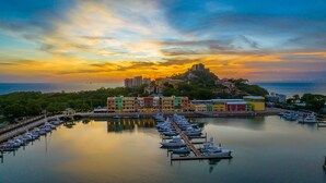 A marina with colorful buildings and boats docked. - Marina Flamingo (Cabo Velas)