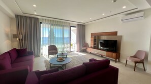 Premium Apartment | Living area | 100-cm LED TV with cable channels, toys, heated floors - Sunraf Luxe Apartments (Becici)