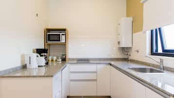 Mini-fridge, microwave, coffee/tea maker, cookware/dishes/utensils